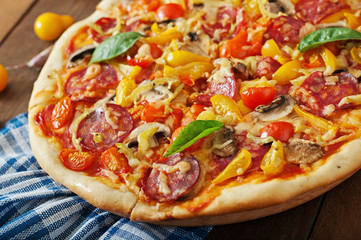 Pizza with salami, tomato, cheese and mushrooms