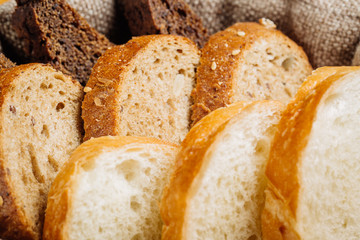 Different types of bread in the basket on the table