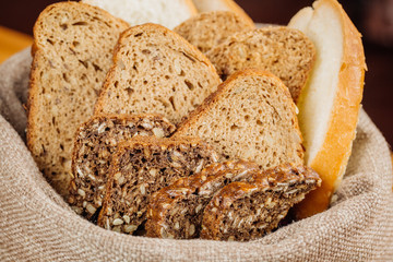 Different types of bread in the basket on the table