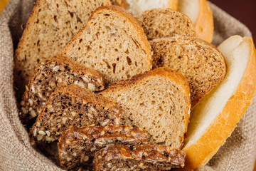 Different types of bread in the basket on the table
