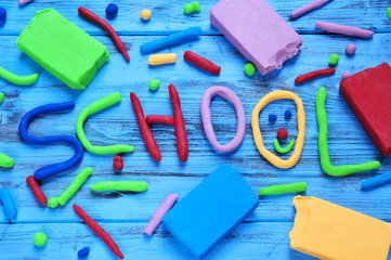word school written with modelling clay of different colors