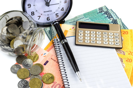 Business and finance concept.Pen,calculator,notepad and clock with money on white background.
