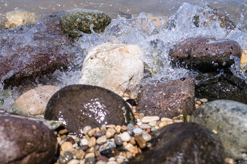 Colorful Rocks with splashing waves on a Beach