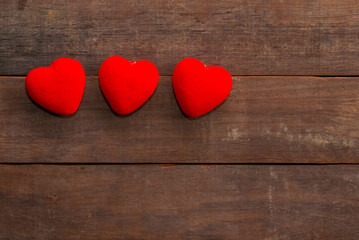 Obraz na płótnie Canvas Valentines Day background with many Hearts on wood.