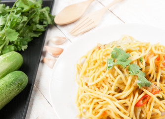 noodles and vegetables on wood