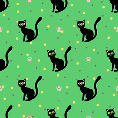 Fototapeta na wymiar Black cats seamless pattern. Sitting black cat on a green background with paw print