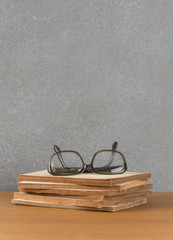 stack of old books with glasses