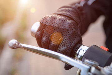protective biker gloves on a motorcycle wheel