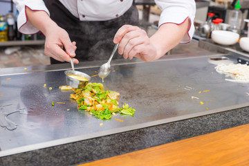 Chef preparing fresh vegetable stir fry