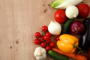 Composition with assorted raw organic vegetables wooden table