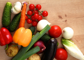 Composition with assorted raw organic vegetables wooden table