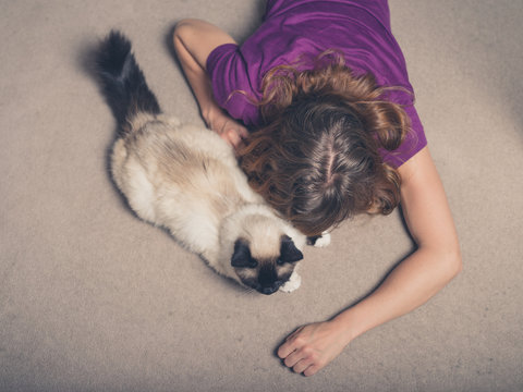 Woman with cat on carpet