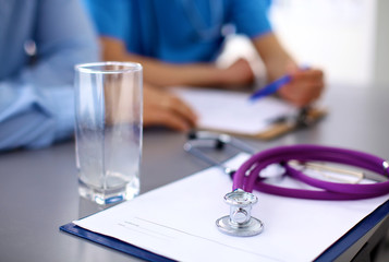 Medical doctor  sitting at table and looking patients roentgen