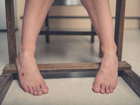 Feet of young woman with a scab