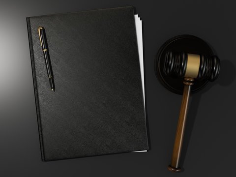 Wooden judges gavel and leather folder on black table