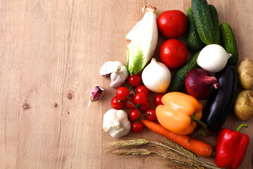Composition with assorted raw organic vegetables wooden table