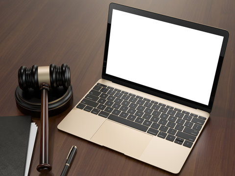 Wooden judges gavel and laptop on the brown wooden background