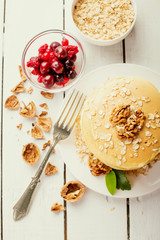 delicious pancakes on a wooden table with nuts
