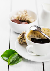Hot cappuccino and pastries on white wooden boards