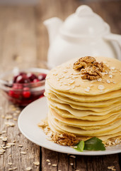 delicious pancakes on a wooden table with nuts