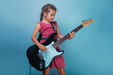 Girl European appearance ten years  playing guitar sings on a bl