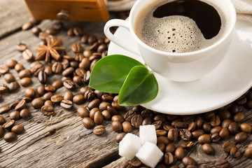 ground coffee in scoop and coffee beans on a wooden background, view from the top
