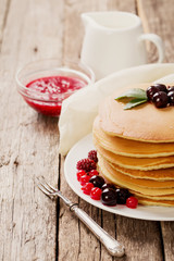delicious pancakes on wooden table with fruits