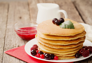 delicious pancakes on wooden table with fruits