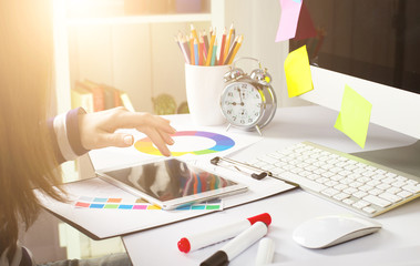 Young woman graphic designer using graphics tablet to do his work