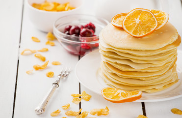 delicious pancakes on wooden table with fruits