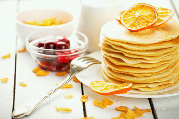 delicious pancakes on wooden table with fruits