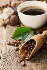 ground coffee in scoop and coffee beans on a wooden background, view from the top