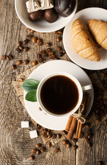 ground coffee in scoop and coffee beans on a wooden background, view from the top