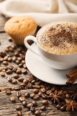 Hot coffee and pastries on a wooden background