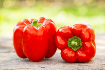 Fresh red pepper on wooden table on nature background