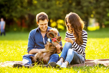 Lifestyle, happy family of two resting at a picnic in the park with a dog