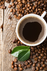 ground coffee in scoop and coffee beans on a wooden background, view from the top