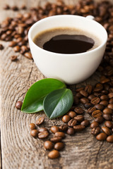 ground coffee in scoop and coffee beans on a wooden background, view from the top
