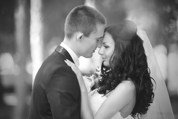 Elegant bride and groom posing together outdoors on a wedding day