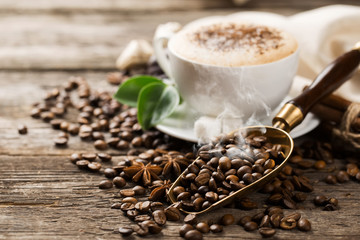 Hot coffee and pastries on a wooden background