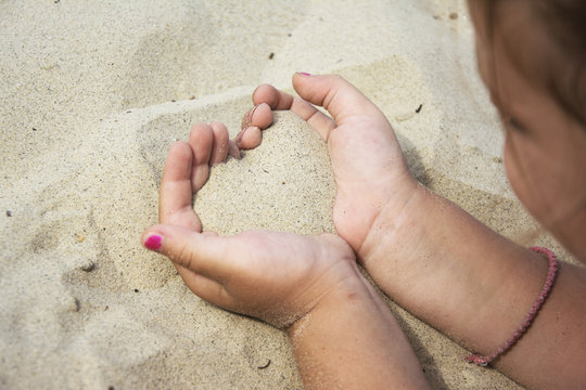 Heart of sand in hands