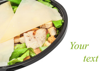 Griddled chicken caesar salad covered with cheese slices parmesan isolated on white background
