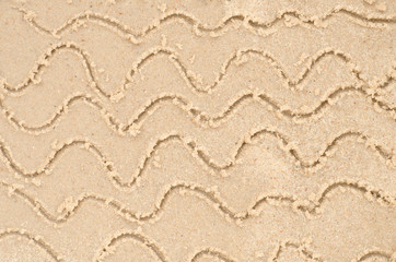 water waves drawing on sand