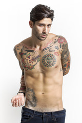 Fototapeta premium Handsome and sexy tattooed man portrait looking at camera