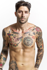 Fototapeta premium Handsome and sexy tattooed man looking at camera