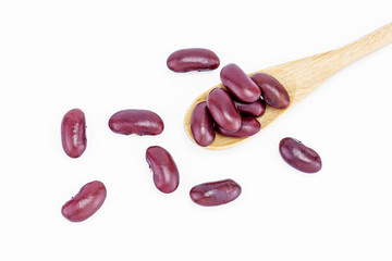 Red kidney beans on a wooden spoon isolate on white