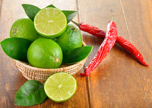 fresh lime and red chilli  on  wooden background