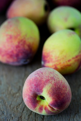 group of fresh peaches on wood background