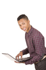 Young hispanic man with casual clothing carrying a laptop and