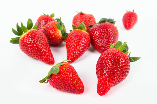 a group of shiny ripe strawberries